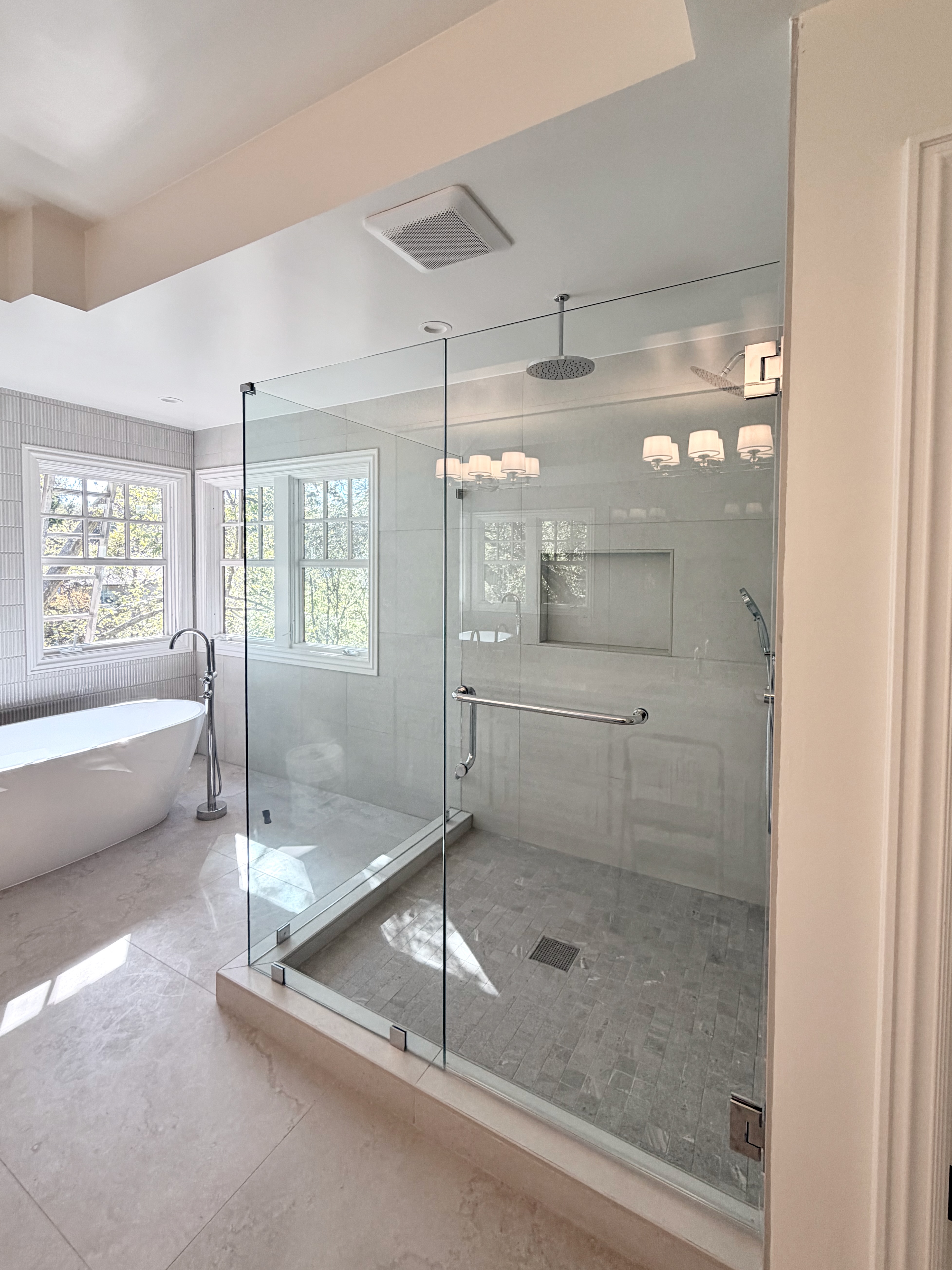 Custom frameless shower enclosure with freestanding tub