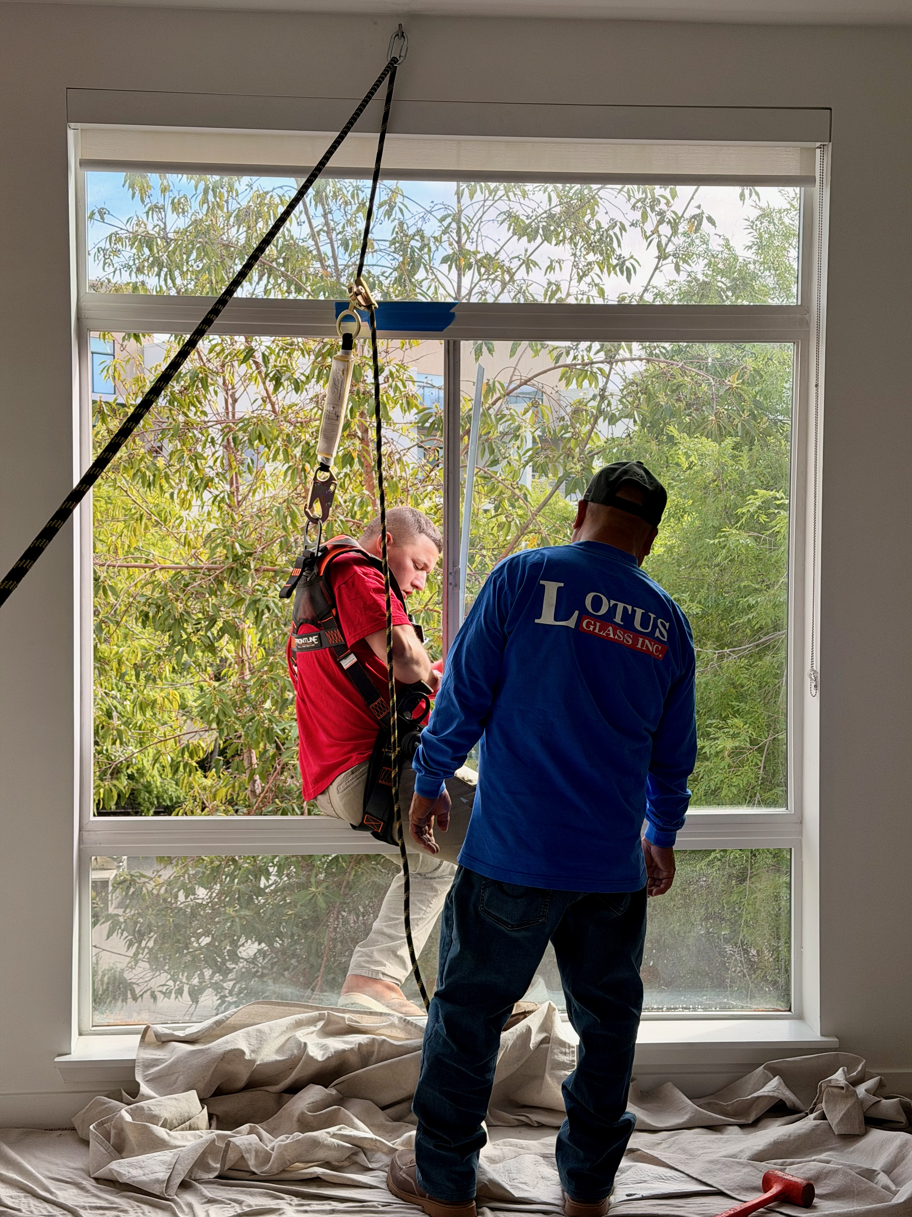Lotus Glass installer at work on a residential window